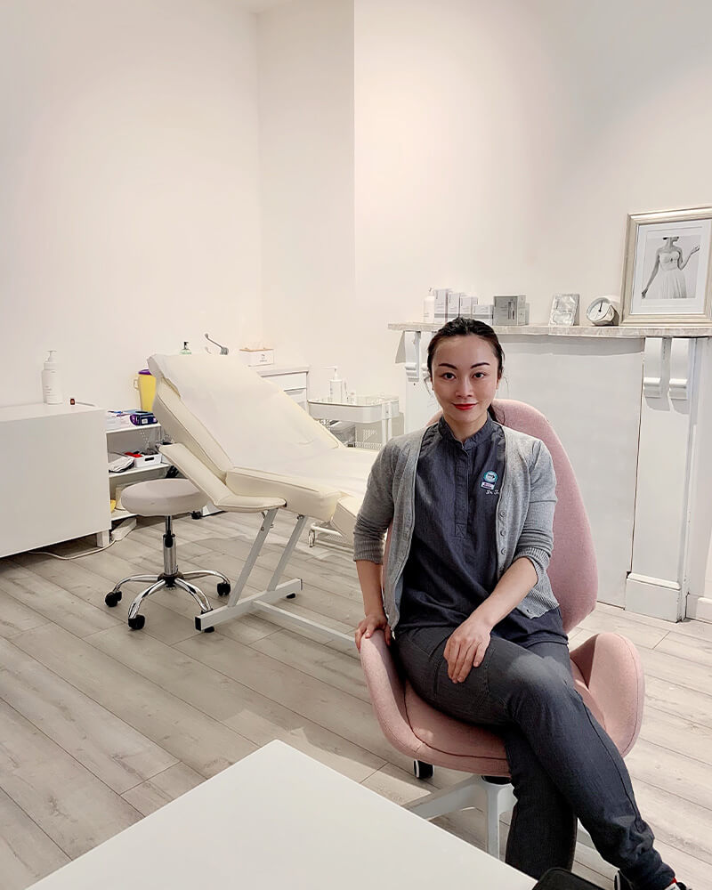 Dr Tracy Xu Sitting on Chair in the Aesthetic Clinic