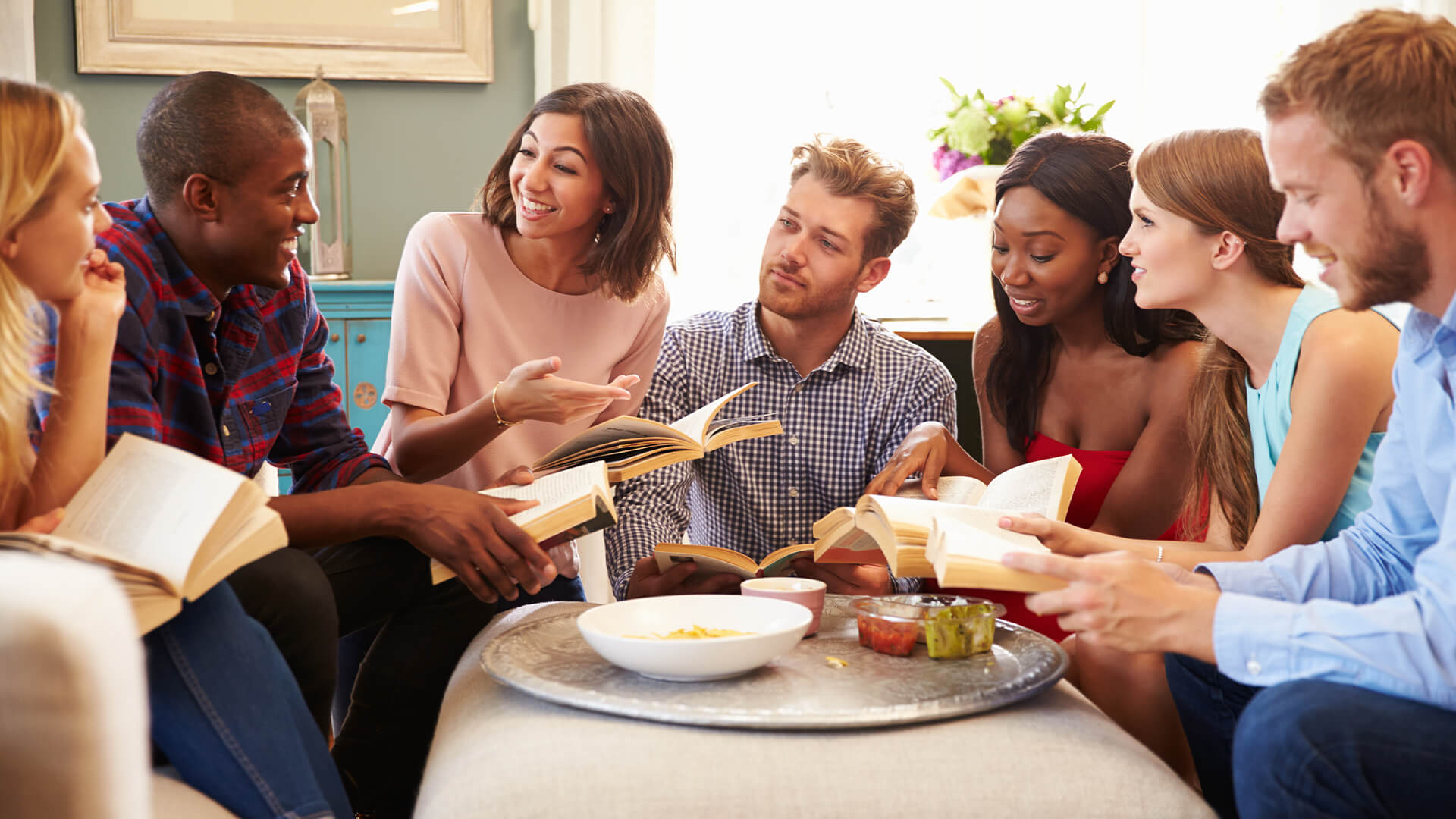 Group Of Friends Taking Part In Book Club At Home
