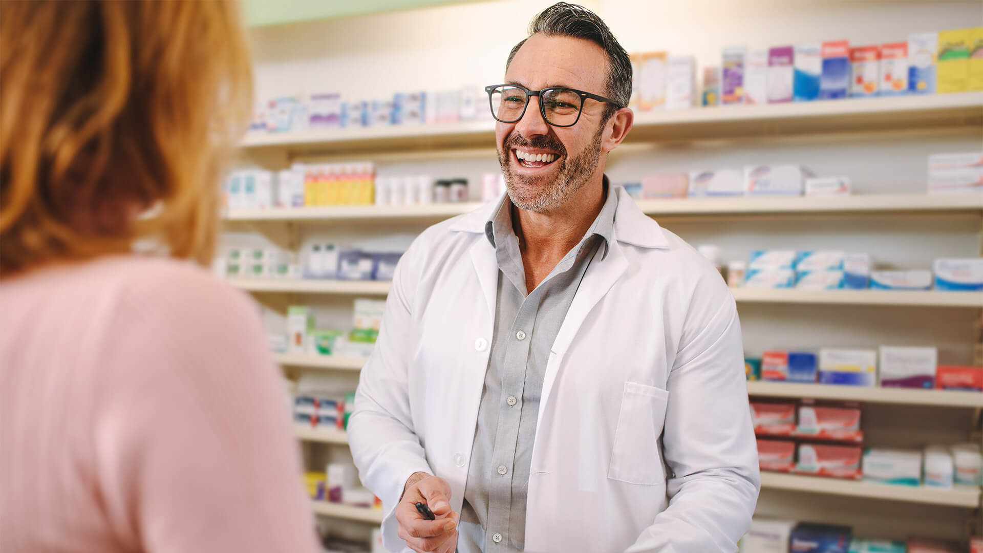 Helpful pharmacist dealing with a woman customer